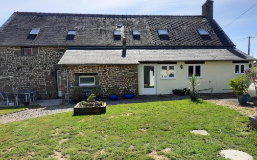 Large stone house with land and outbuildings.
