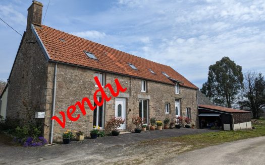 Large stone house with land and outbuildings.
